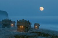 Image of trucks taking sand from a beach in the middle of the night.